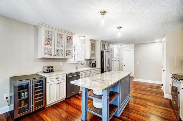 2474 Marthas Wood, Grove City, OH 43123 - kitchen featuring appliances with stainless steel finishes, wine cooler, dark wood-type flooring, a kitchen island, and glass insert cabinets