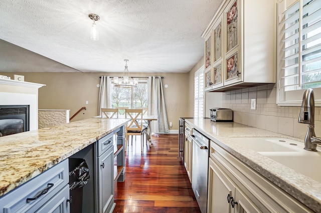 2474 Marthas Wood, Grove City, OH 43123 - kitchen with stainless steel dishwasher, dark wood-style floors, a chandelier, decorative backsplash, and glass insert cabinets