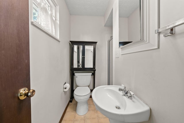 12475 Oak Dr, Orient, OH 43146 - full bath with a shower with door, tile patterned flooring, and a textured ceiling