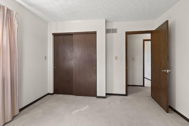 12475 Oak Dr, Orient, OH 43146 - unfurnished bedroom with light carpet, a closet, and a textured ceiling