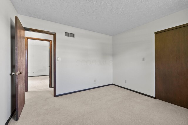 12475 Oak Dr, Orient, OH 43146 - unfurnished bedroom with light carpet and a textured ceiling