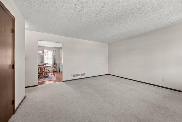 12475 Oak Dr, Orient, OH 43146 - empty room featuring a chandelier, carpet, and a textured ceiling