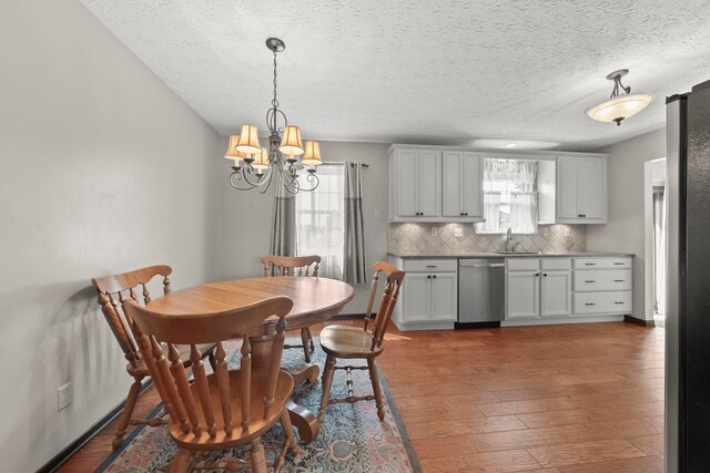 12475 Oak Dr, Orient, OH 43146 - dining space featuring a chandelier, plenty of natural light, hardwood / wood-style flooring, and a textured ceiling
