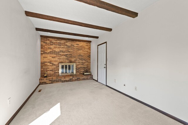 12475 Oak Dr, Orient, OH 43146 - unfurnished living room featuring beam ceiling, a brick fireplace, and light colored carpet