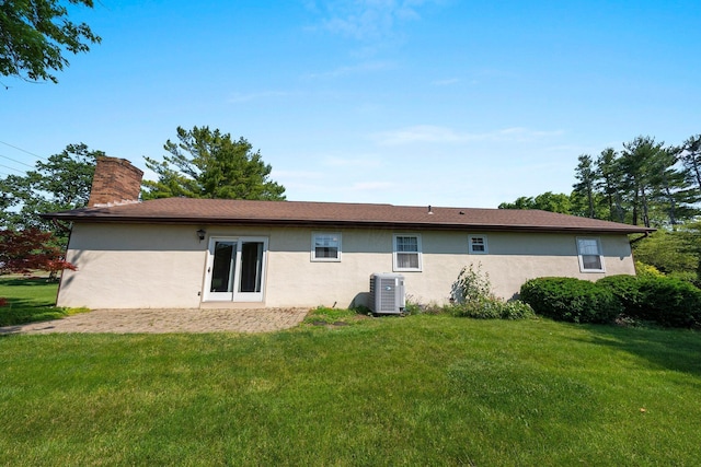 12475 Oak Dr, Orient, OH 43146 - back of property featuring stucco siding, a chimney, and a yard