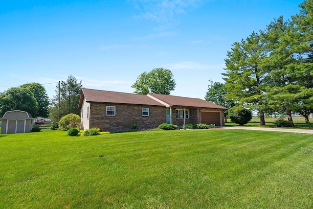 12475 Oak Dr, Orient, OH 43146 - ranch-style home featuring a garage, concrete driveway, a front lawn, a storage unit, and brick siding