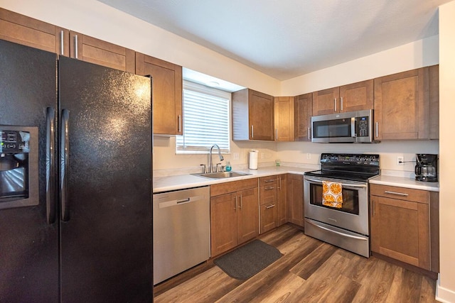 81 3rd Ave SW, Etna, OH 43062 - kitchen featuring stainless steel appliances, dark wood-style floors, light countertops, and brown cabinets