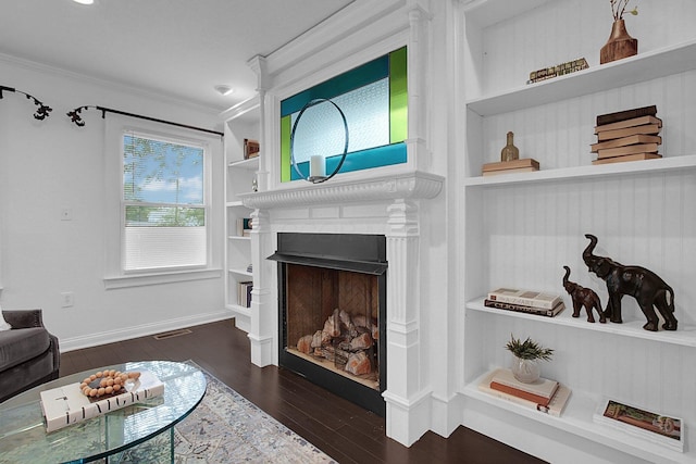1225 Eastview Ave, Grandview Heights, OH 43212 - living area featuring dark wood-type flooring, ornamental molding, built in features, and a fireplace