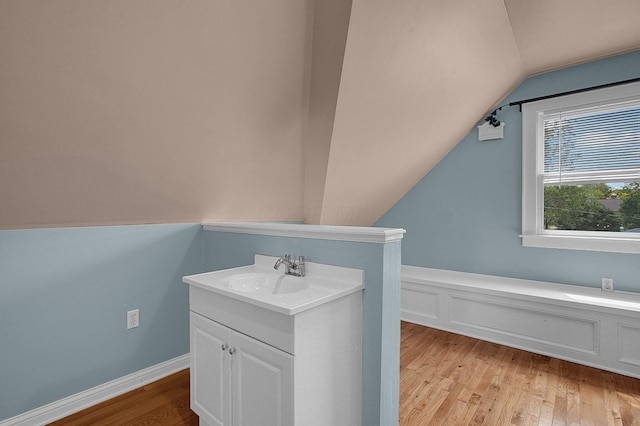 1225 Eastview Ave, Grandview Heights, OH 43212 - bathroom featuring vaulted ceiling, wood finished floors, vanity, and a wainscoted wall