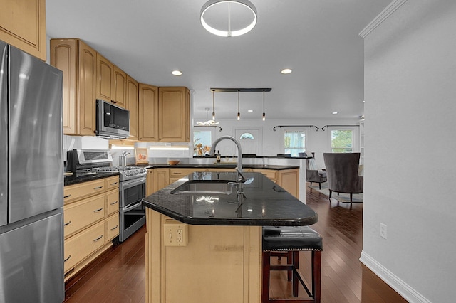 1225 Eastview Ave, Grandview Heights, OH 43212 - kitchen with stainless steel appliances, dark wood-type flooring, a peninsula, a breakfast bar, and recessed lighting