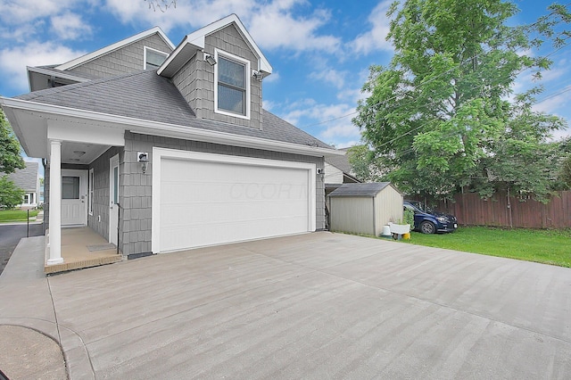 1225 Eastview Ave, Grandview Heights, OH 43212 - view of front facade featuring a shed, a garage, concrete driveway, and roof with shingles