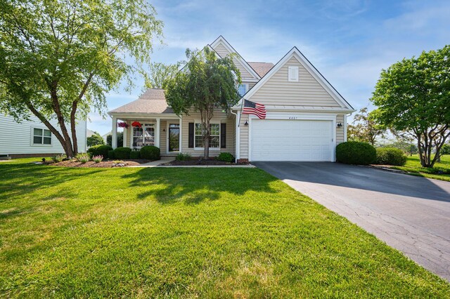 4401 Kathryns Way, Hilliard, OH 43026 - traditional-style house featuring driveway, a front lawn, covered porch, and a garage