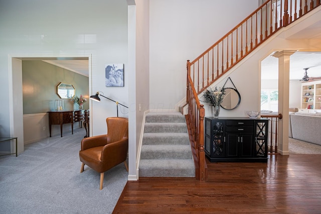 4401 Kathryns Way, Hilliard, OH 43026 - staircase with decorative columns, wood finished floors, carpet flooring, and ornamental molding