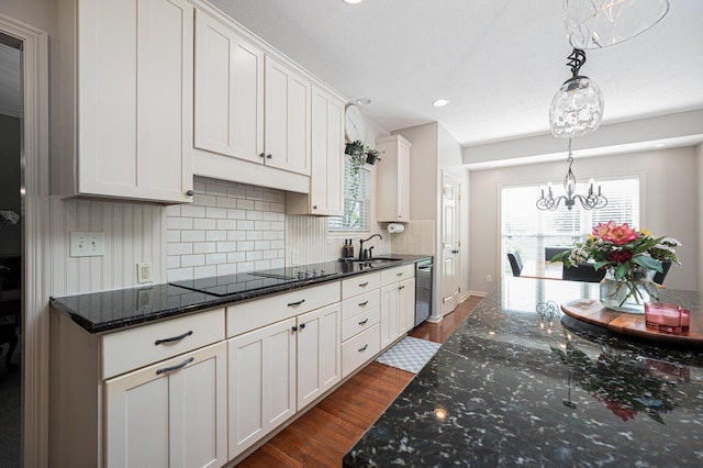 4401 Kathryns Way, Hilliard, OH 43026 - kitchen featuring black electric cooktop, stainless steel dishwasher, dark wood finished floors, a chandelier, and white cabinetry