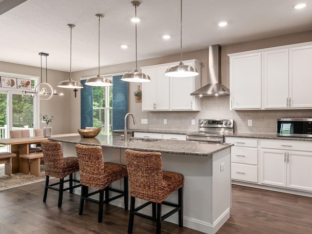 404 Colony Ridge Dr, Delaware, OH 43015 - kitchen featuring wall chimney exhaust hood, stainless steel appliances, dark wood-type flooring, recessed lighting, and tasteful backsplash