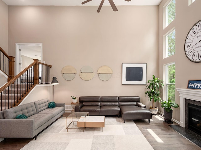 404 Colony Ridge Dr, Delaware, OH 43015 - living area featuring a high ceiling, wood finished floors, ceiling fan, stairs, and a high end fireplace