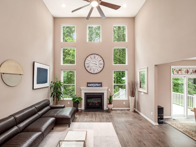 404 Colony Ridge Dr, Delaware, OH 43015 - living area with a ceiling fan, wood finished floors, a high ceiling, healthy amount of natural light, and a high end fireplace