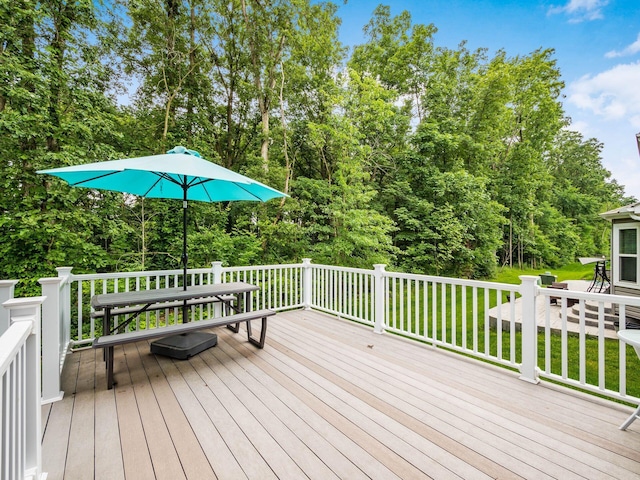 404 Colony Ridge Dr, Delaware, OH 43015 - wooden deck featuring outdoor dining area, a lawn, and view of scattered trees