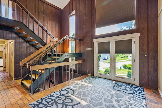 933 Creek Run Ct, Westerville, OH 43081 - entrance foyer featuring brick floors, wood walls, plenty of natural light, french doors, and stairway