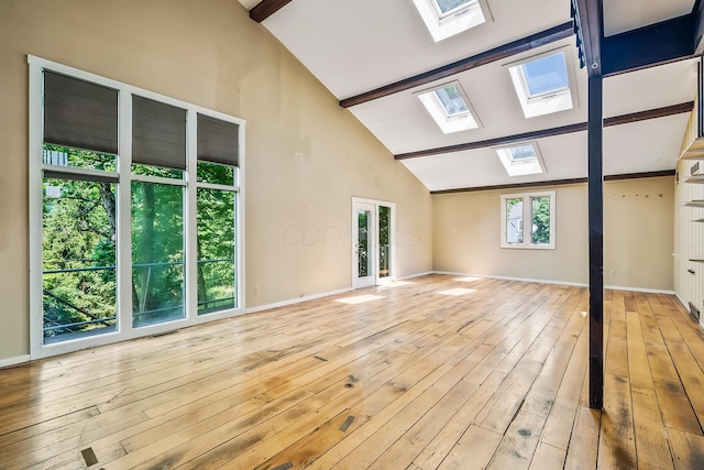 933 Creek Run Ct, Westerville, OH 43081 - unfurnished living room featuring a skylight, beamed ceiling, high vaulted ceiling, and light wood-style flooring