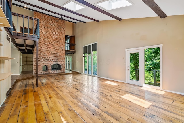 933 Creek Run Ct, Westerville, OH 43081 - unfurnished living room with a skylight, beamed ceiling, a fireplace, plenty of natural light, and a high ceiling