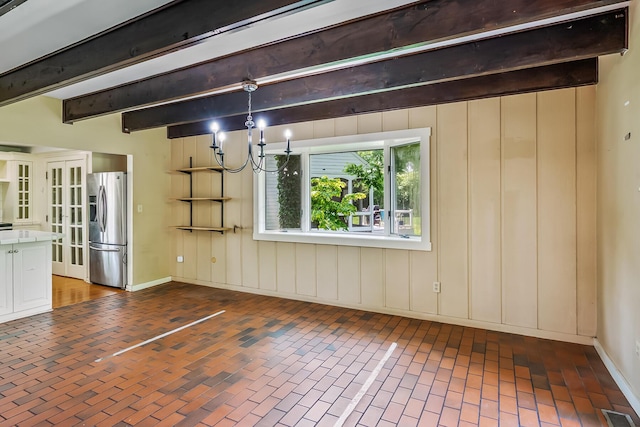 933 Creek Run Ct, Westerville, OH 43081 - unfurnished living room with brick patterned flooring, a chandelier, and beamed ceiling