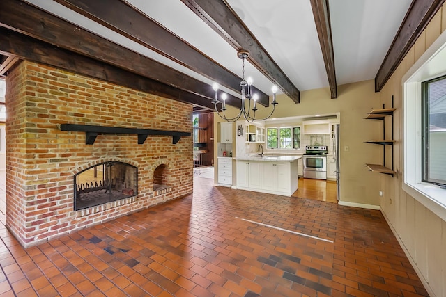 933 Creek Run Ct, Westerville, OH 43081 - unfurnished living room featuring brick flooring, a brick fireplace, beamed ceiling, and a chandelier