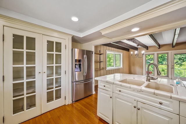 933 Creek Run Ct, Westerville, OH 43081 - kitchen featuring stainless steel refrigerator with ice dispenser, tile counters, light wood-type flooring, recessed lighting, and a chandelier