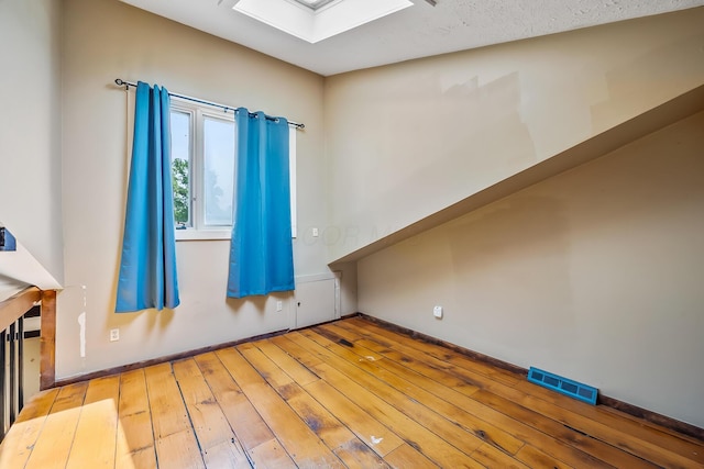 933 Creek Run Ct, Westerville, OH 43081 - spare room with wood-type flooring and a skylight