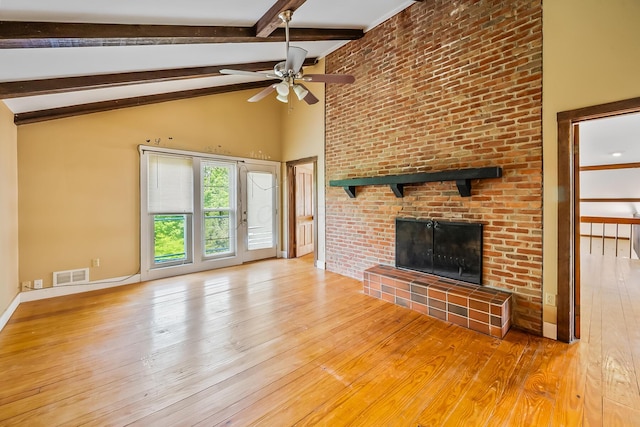 933 Creek Run Ct, Westerville, OH 43081 - unfurnished living room with wood-type flooring, a ceiling fan, beam ceiling, a brick fireplace, and high vaulted ceiling