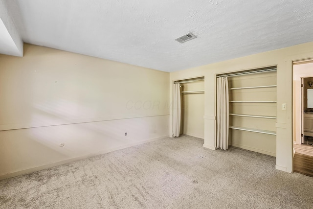 933 Creek Run Ct, Westerville, OH 43081 - unfurnished bedroom featuring multiple closets, carpet flooring, and a textured ceiling