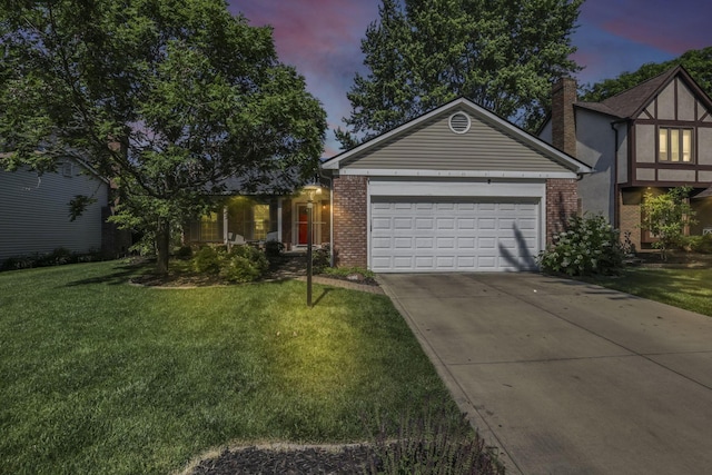 7881 Saddle, Powell, OH 43065 - view of front of house featuring brick siding, concrete driveway, a front lawn, and an attached garage
