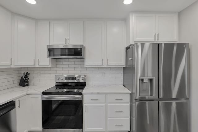 7881 Saddle, Powell, OH 43065 - kitchen with appliances with stainless steel finishes, white cabinets, tasteful backsplash, light stone counters, and recessed lighting