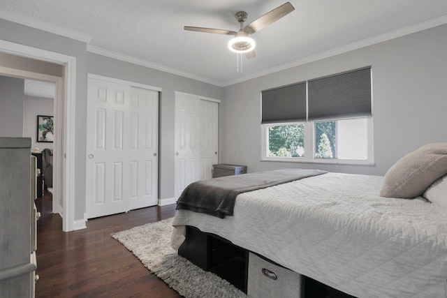 7881 Saddle, Powell, OH 43065 - bedroom with two closets, dark wood-type flooring, ornamental molding, and ceiling fan