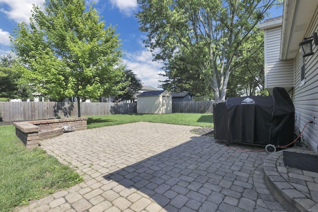 7881 Saddle, Powell, OH 43065 - fenced backyard with a storage unit, a patio, and a grill