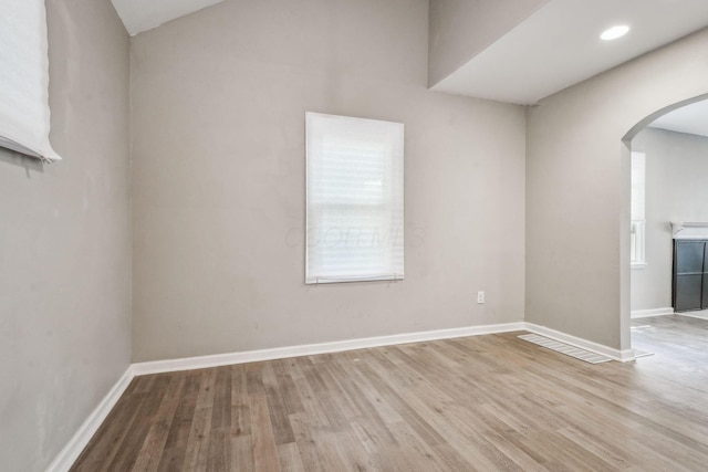 1328 Republic Ave, Columbus, OH 43211 - spare room featuring arched walkways, wood finished floors, and lofted ceiling