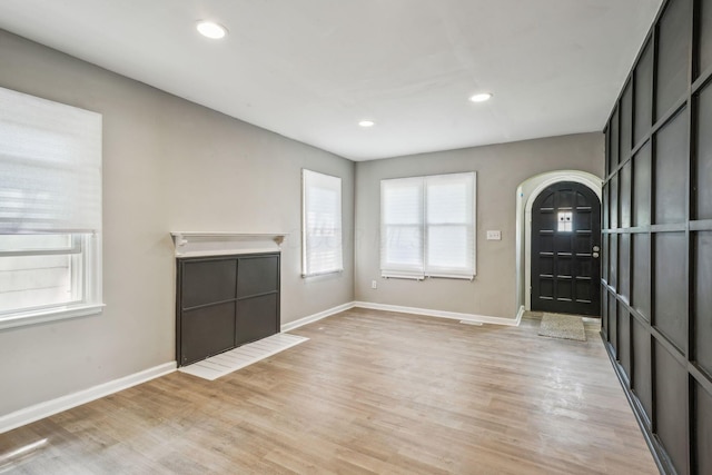 1328 Republic Ave, Columbus, OH 43211 - unfurnished living room with arched walkways, light wood finished floors, and recessed lighting