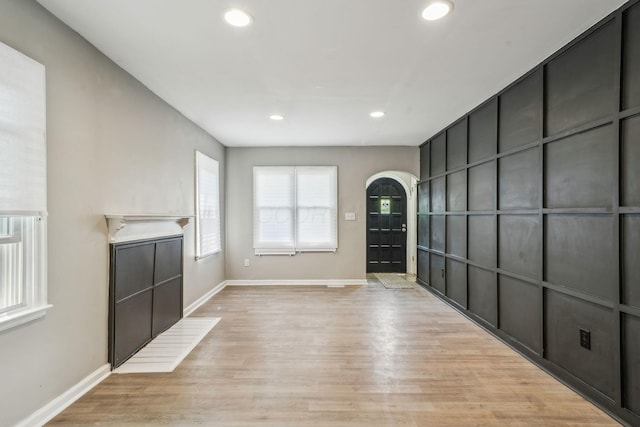 1328 Republic Ave, Columbus, OH 43211 - unfurnished living room with recessed lighting, arched walkways, and light wood-type flooring
