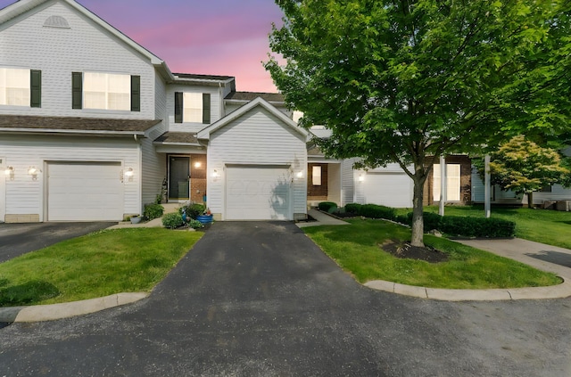 3984 Hill Park Rd, Hilliard, OH 43026 - view of front of home with driveway, a yard, a garage, and brick siding