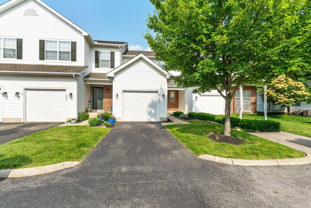 3984 Hill Park Rd, Hilliard, OH 43026 - view of front of house with driveway, a front lawn, and brick siding