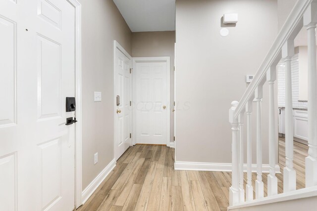 3984 Hill Park Rd, Hilliard, OH 43026 - foyer entrance with light wood-style floors and stairs
