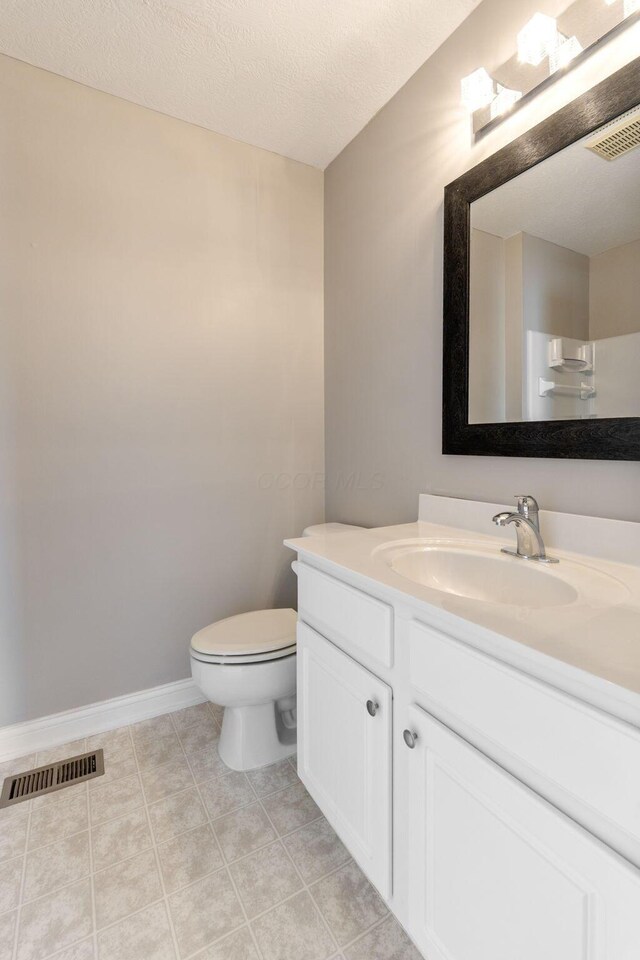 3984 Hill Park Rd, Hilliard, OH 43026 - bathroom with vanity, a textured ceiling, and tile patterned flooring