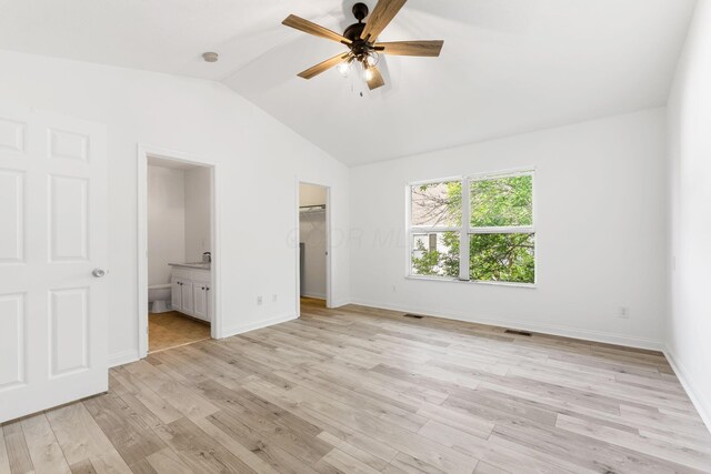 3984 Hill Park Rd, Hilliard, OH 43026 - unfurnished bedroom with vaulted ceiling, a walk in closet, ensuite bathroom, light wood-type flooring, and a closet