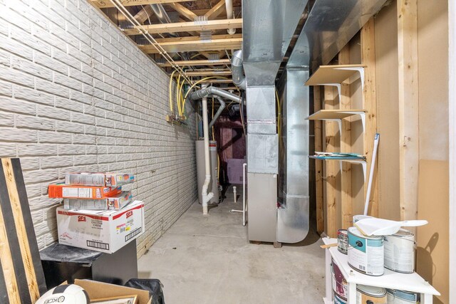 3984 Hill Park Rd, Hilliard, OH 43026 - unfinished below grade area with water heater, heating unit, and brick wall