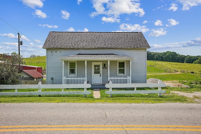 5505 Hopewell Church Rd SW, Lancaster, OH 43130 - view of front of house with a porch, a fenced front yard, and roof with shingles