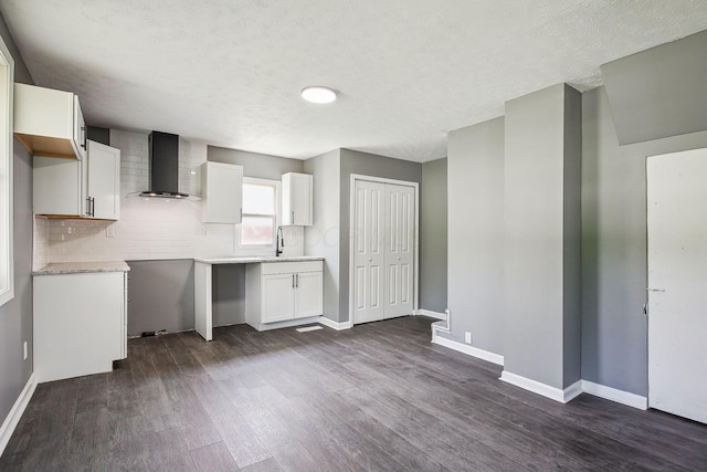5505 Hopewell Church Rd SW, Lancaster, OH 43130 - kitchen with wall chimney exhaust hood, dark wood finished floors, white cabinetry, a textured ceiling, and decorative backsplash