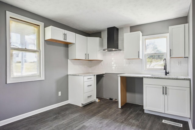 5505 Hopewell Church Rd SW, Lancaster, OH 43130 - kitchen featuring wall chimney range hood, dark wood finished floors, backsplash, and white cabinets