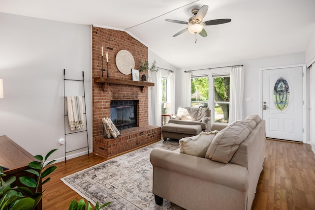 3776 Secretariat Ct, Columbus, OH 43221 - living room featuring lofted ceiling, wood finished floors, a ceiling fan, and a brick fireplace