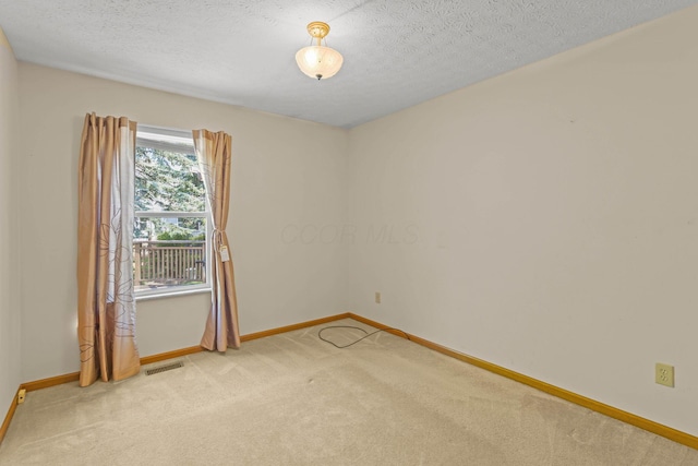 8544 Cadence Dr, Galloway, OH 43119 - empty room featuring light carpet and a textured ceiling