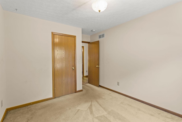 8544 Cadence Dr, Galloway, OH 43119 - empty room featuring light carpet, a textured ceiling, and a smoke detector